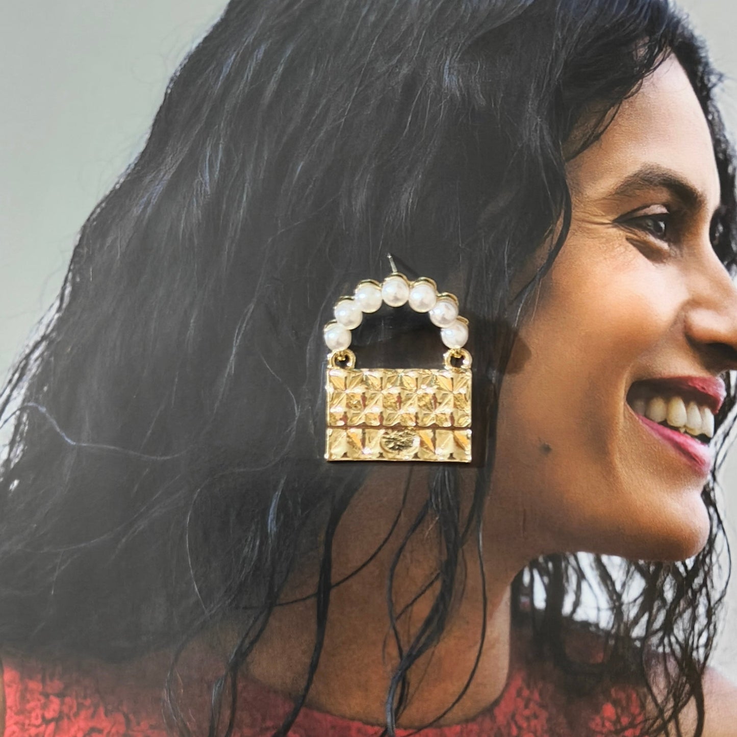 Golden bag earrings.
(Only meant to carry feelings)