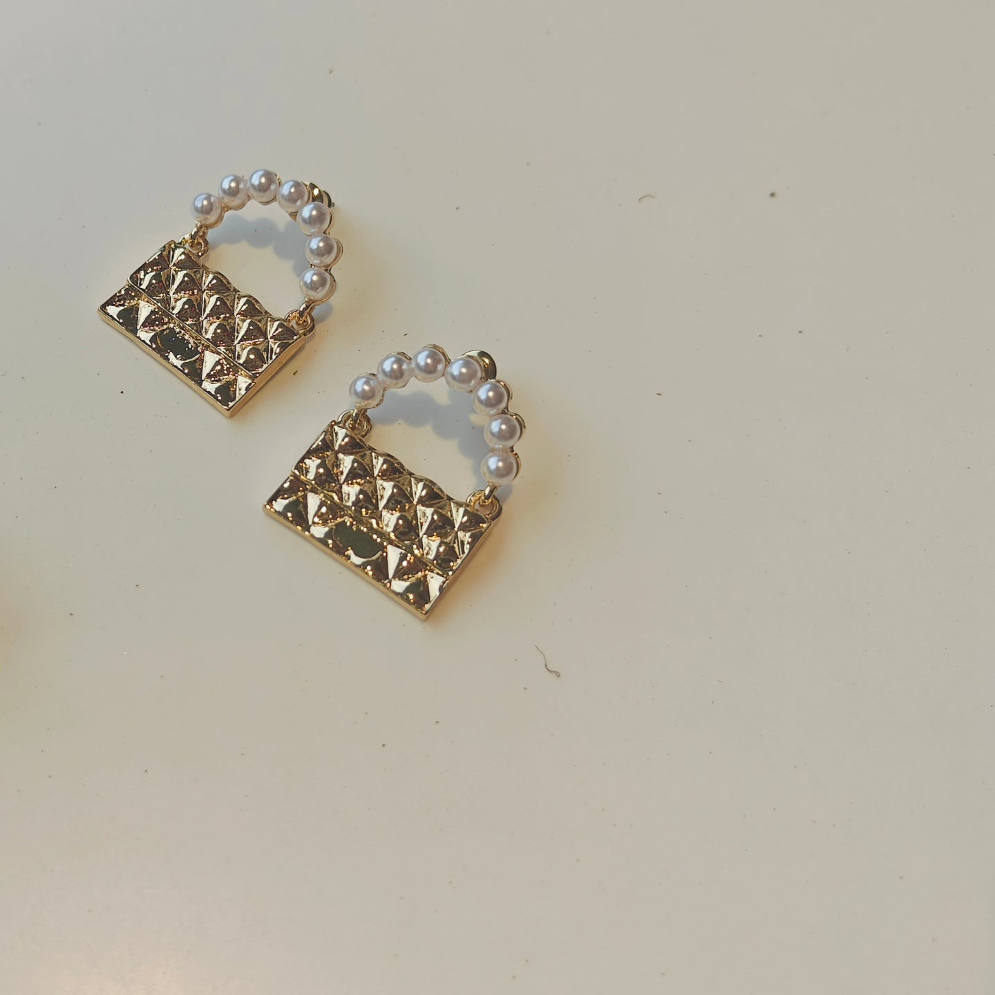 Golden bag earrings.
(Only meant to carry feelings)